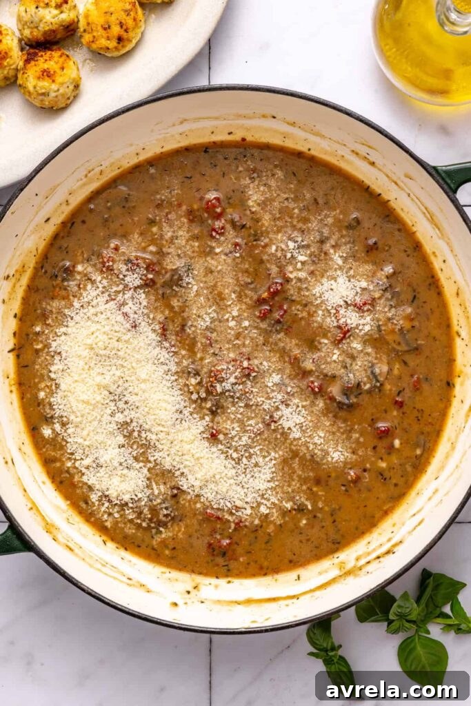 Adding Parmesan to sauce for rich chicken meatballs
