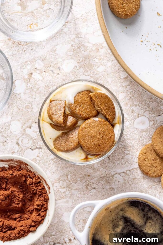 Adding second layer of espresso-soaked cookies to tiramisu