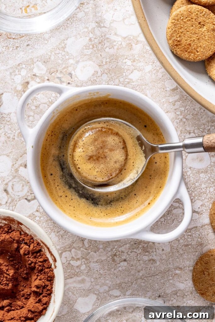 Dipping gluten-free cookies into espresso for tiramisu cups