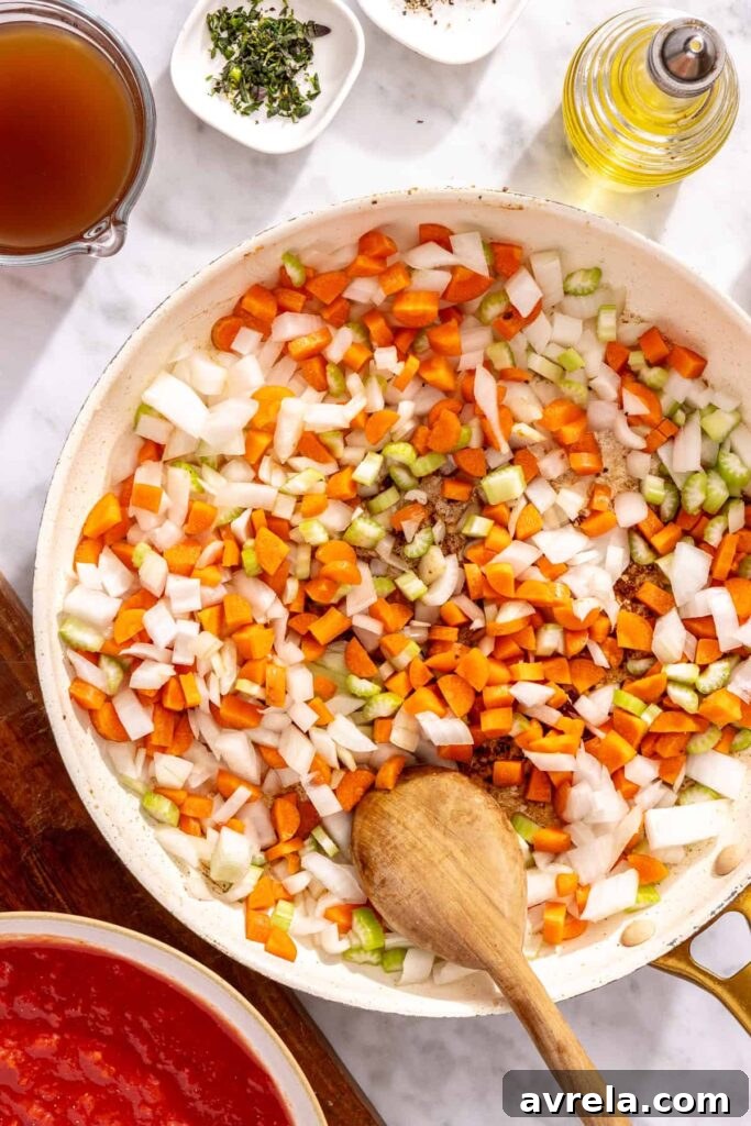 Onion carrots and celery sautéing in pan for short rib ragu base