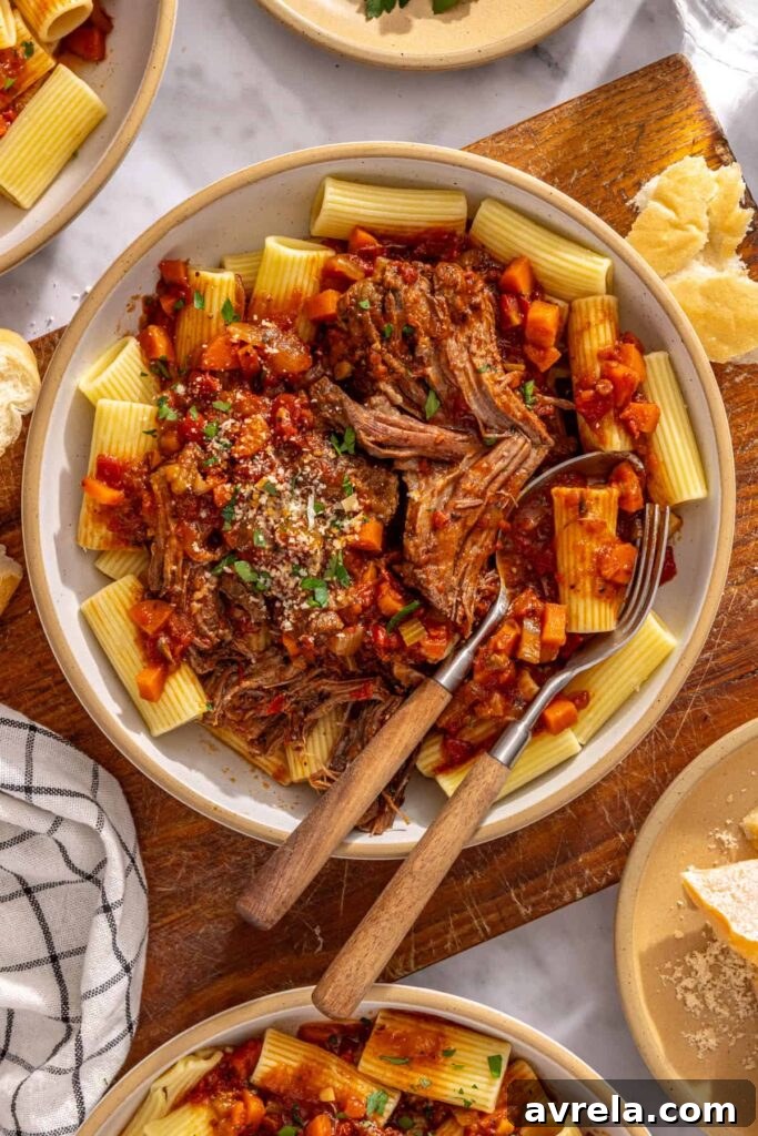 Healthy slow cooker short rib ragu served over noodles