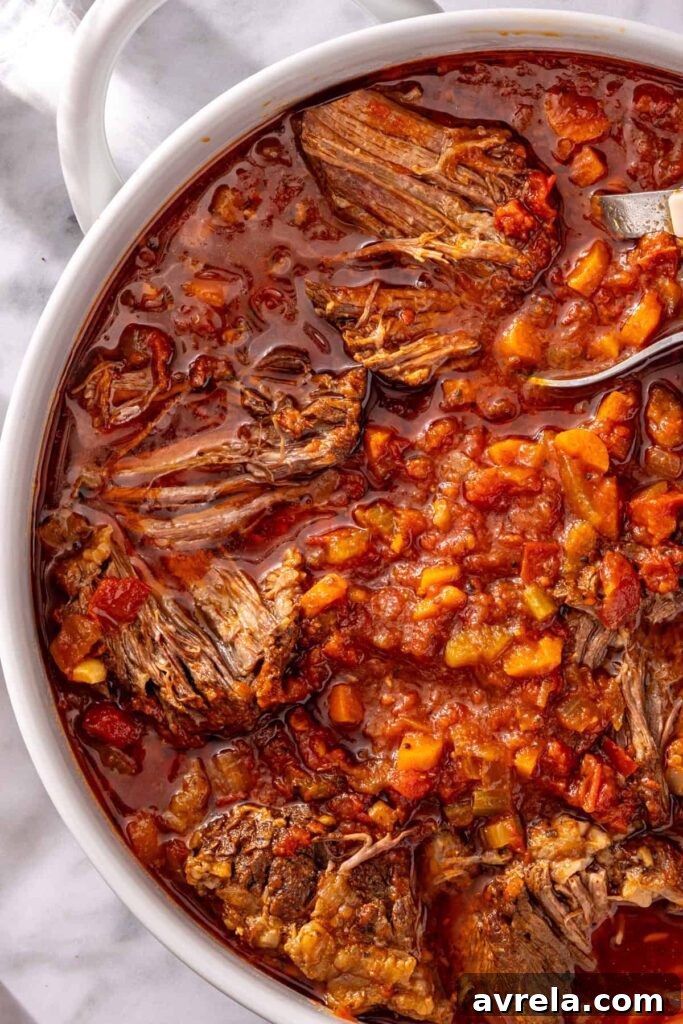 Close-up of juicy shredded beef in ragu sauce