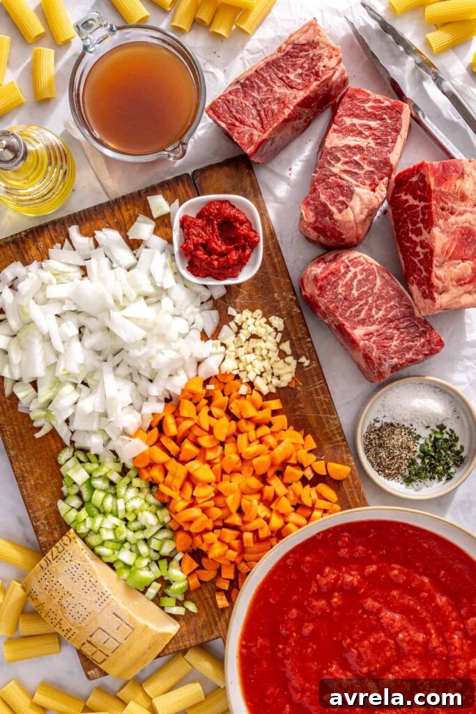 Healthy short rib ragu ingredients laid out including grass-fed beef short ribs and fresh vegetables