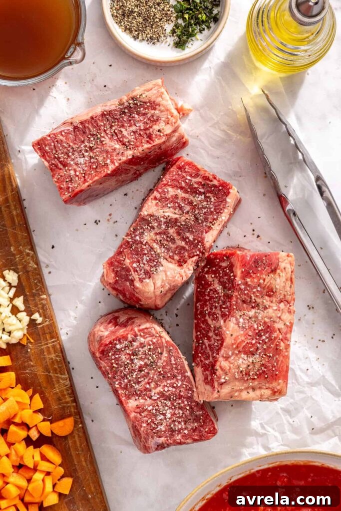 Beef short ribs seasoned with salt and pepper for short rib ragu
