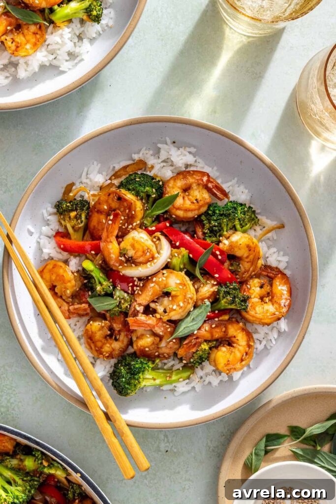 Styled shrimp stir fry scene with chopsticks, and simple table setting
