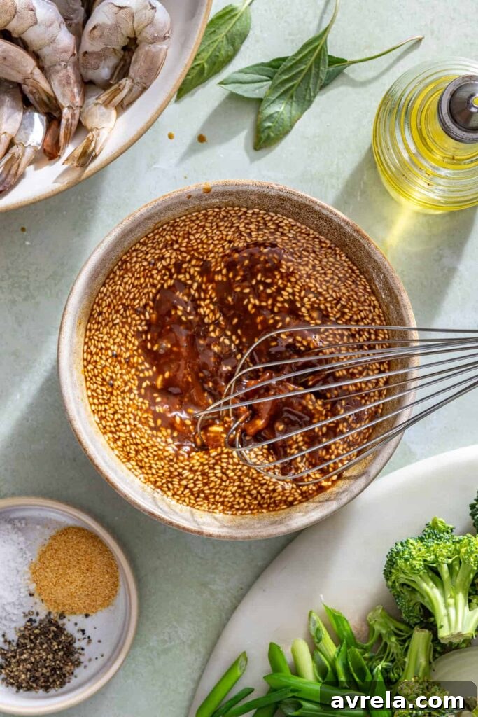 Whisking homemade stir fry sauce with coconut aminos, honey, garlic, and ginger