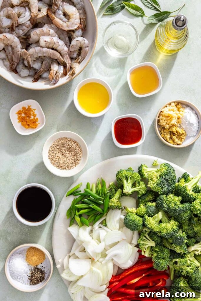 Ingredients laid out for easy shrimp stir fry with fresh vegetables, shrimp, and homemade sauce