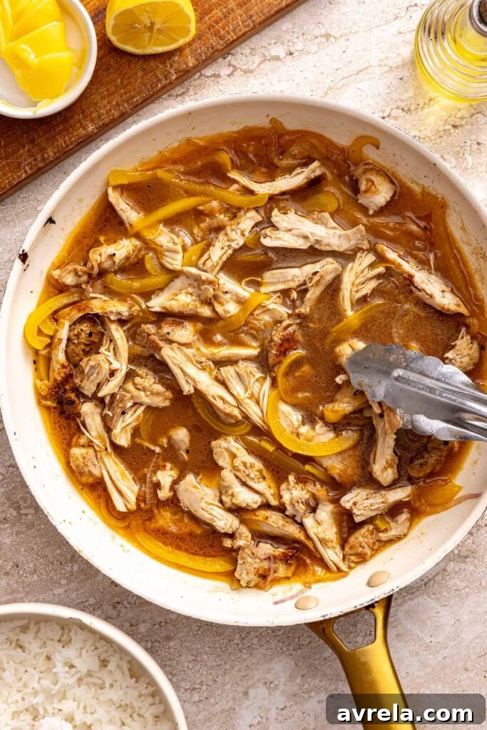 Cooking chicken thighs with broth and vegetables for rice bowls