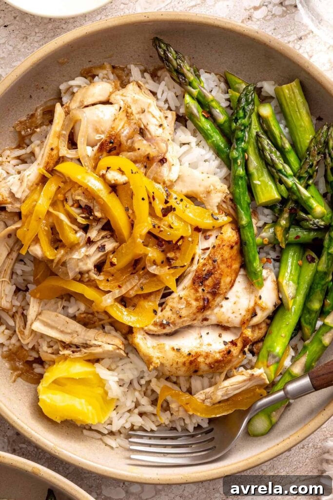 Wholesome Chicken Thigh Rice Bowls 11 A close-up shot showing a pat of ghee melting deliciously over the warm shredded chicken and rice
