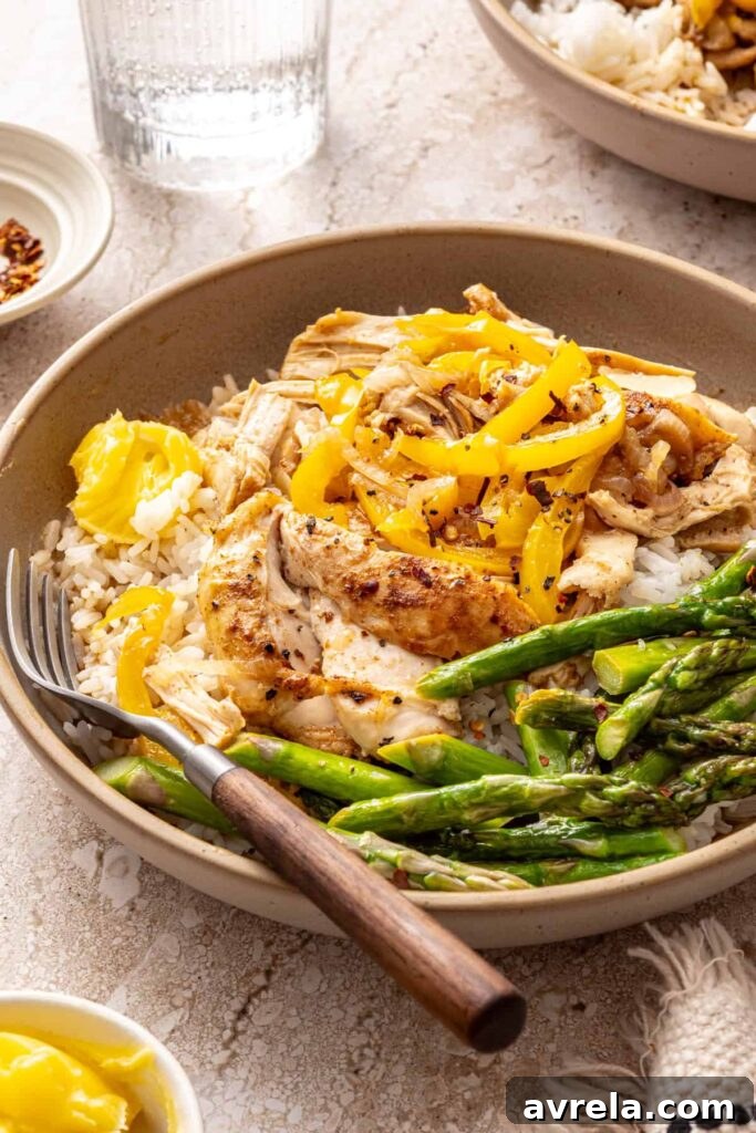 Angled shot of healthy chicken thigh rice bowl with toppings