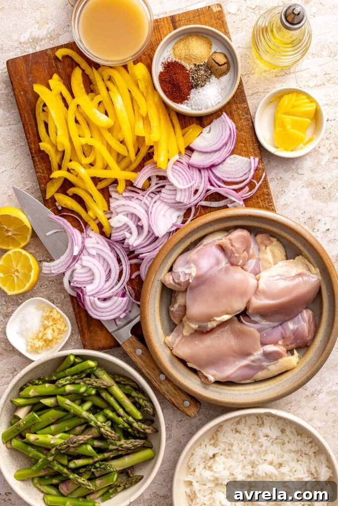 Wholesome Chicken Thigh Rice Bowls 7 Flat-lay of fresh ingredients for chicken thigh rice bowls, including chicken, asparagus, peppers, and spices