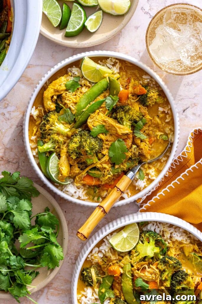 crockpot chicken curry bowl with spoon, napkins, and lime wedges