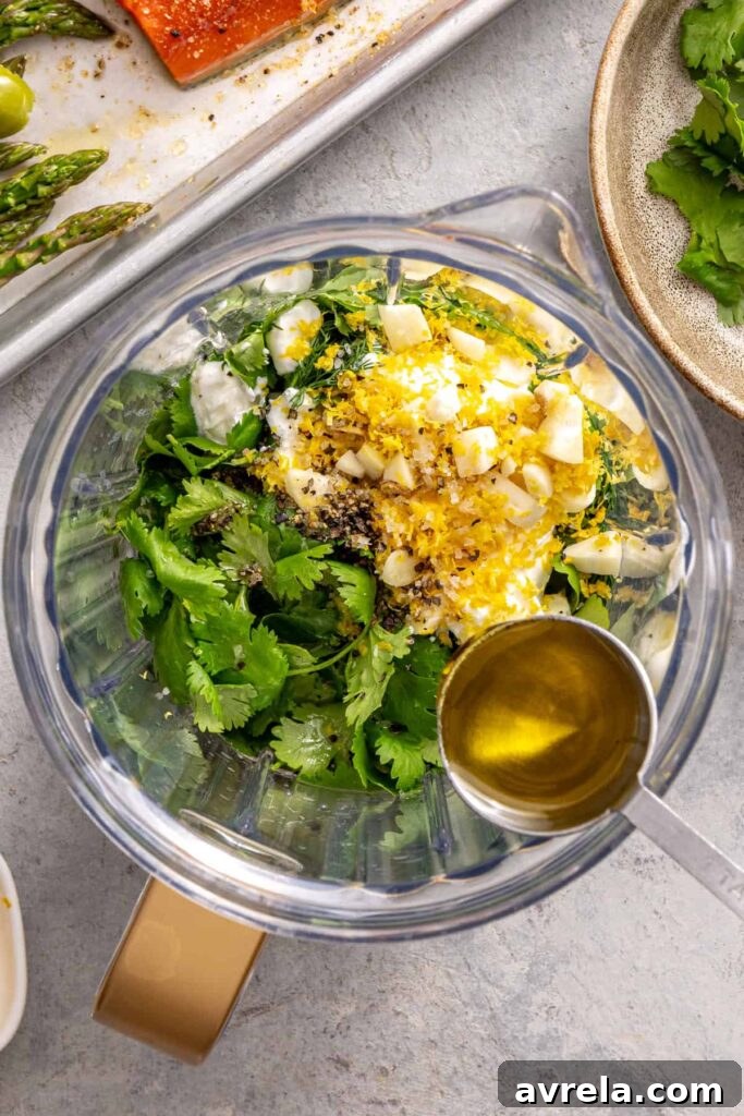 Fresh herbs, yogurt, garlic, and lemon added to blender for sauce