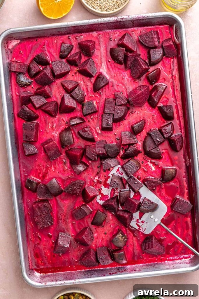 Tender roasted beets cooling on a sheet pan