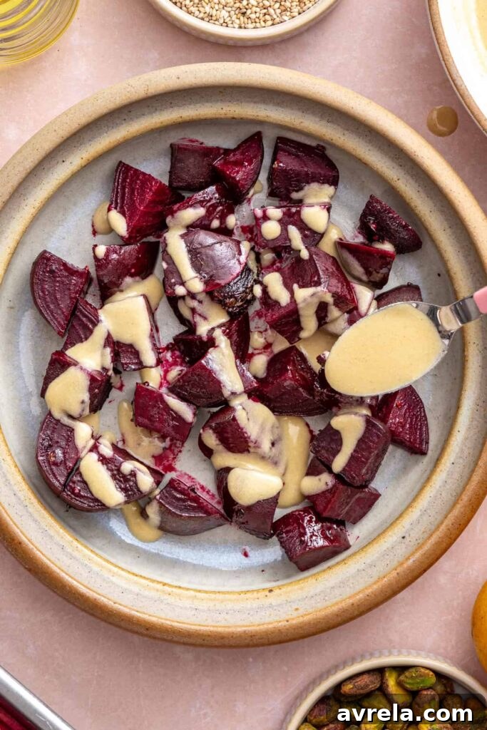 Mixing roasted beets with dressing for beet salad