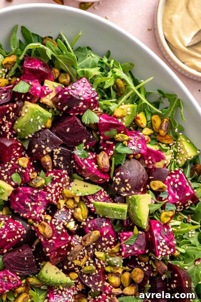 Overhead shot of beet salad with goat cheese and arugula on a serving platter
