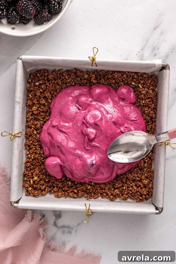 Spreading blackberry layer evenly over crust