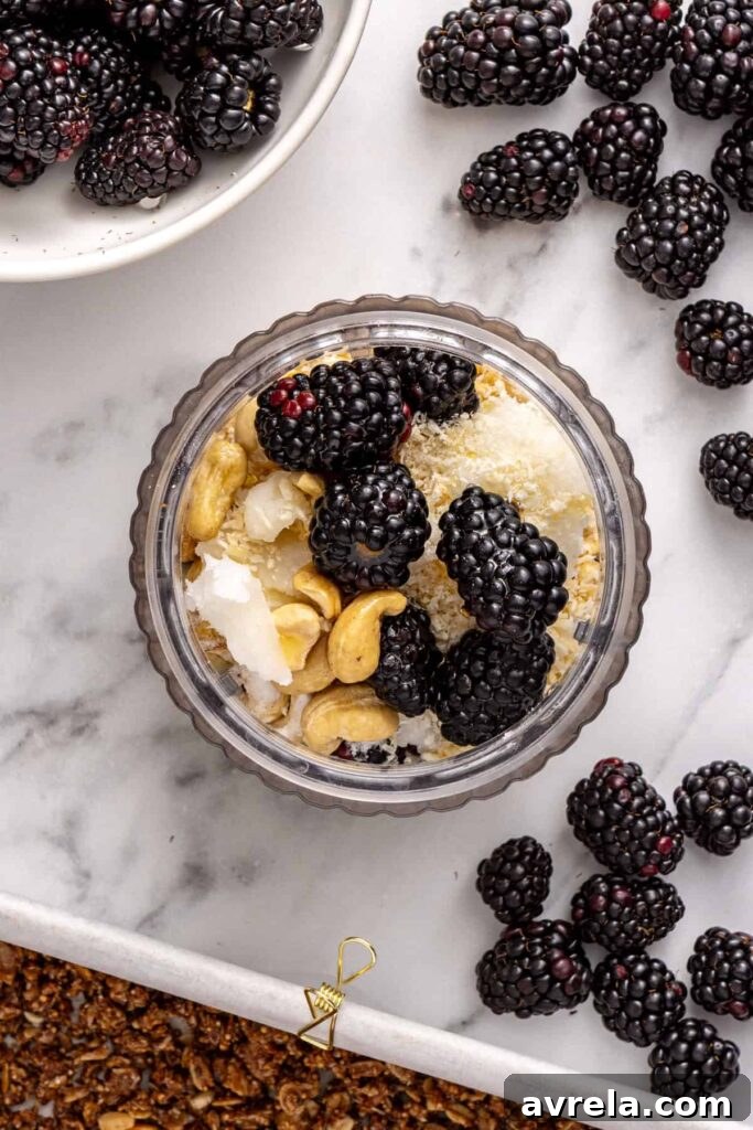 Blender filled with blackberry mixture for healthy dessert bars
