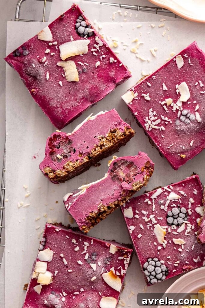 Overhead of frozen blackberry cobbler bars on parchment-lined rack