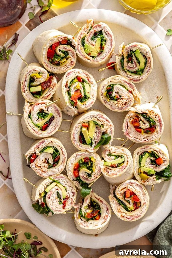 Turkey pinwheels secured with toothpicks on serving platter