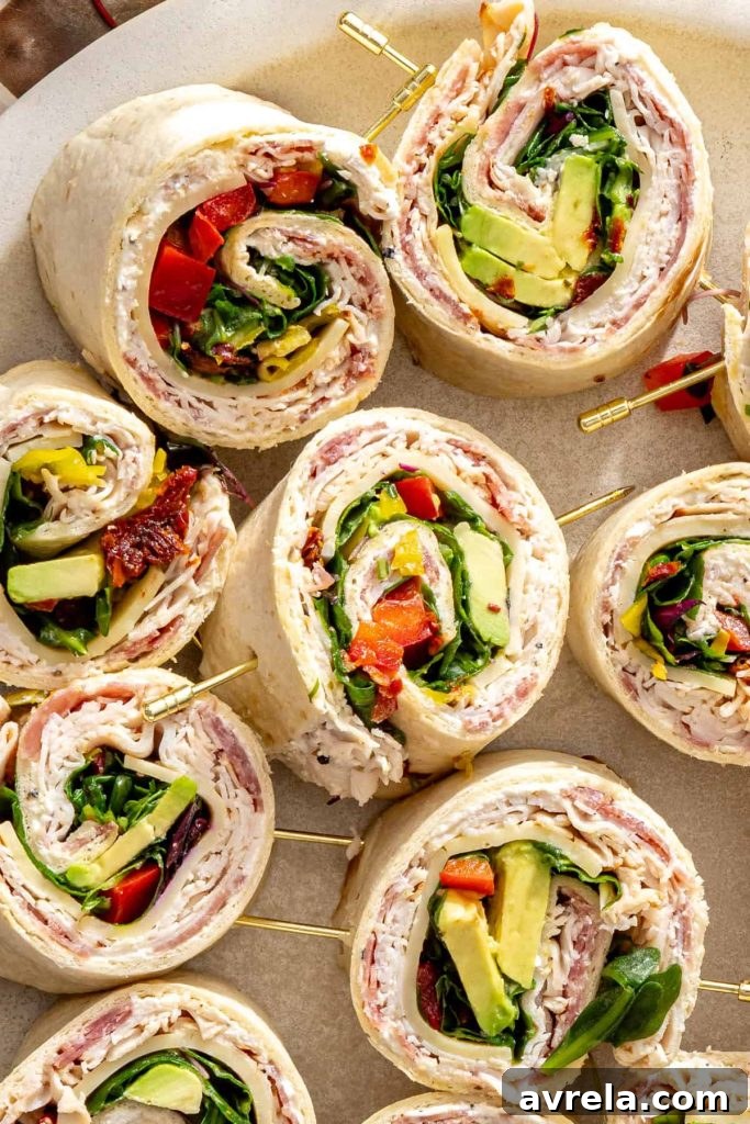 Close overhead shot of turkey pinwheels with avocado and goat cheddar