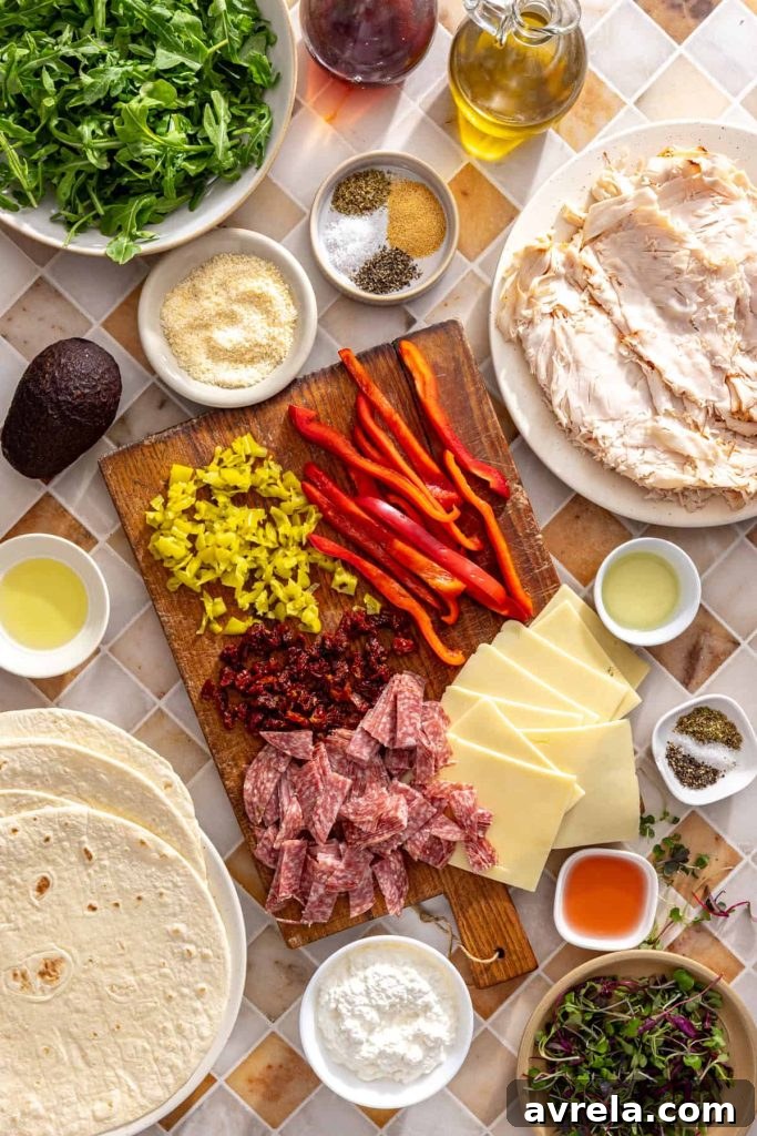Ingredients for high-protein turkey pinwheels including turkey, cottage cheese, arugula, avocado, salami, and cassava tortillas
