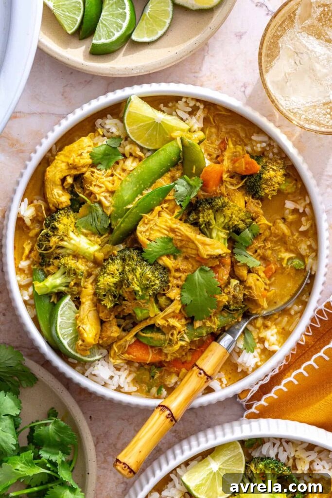slow cooker chicken curry served over rice with cilantro garnish