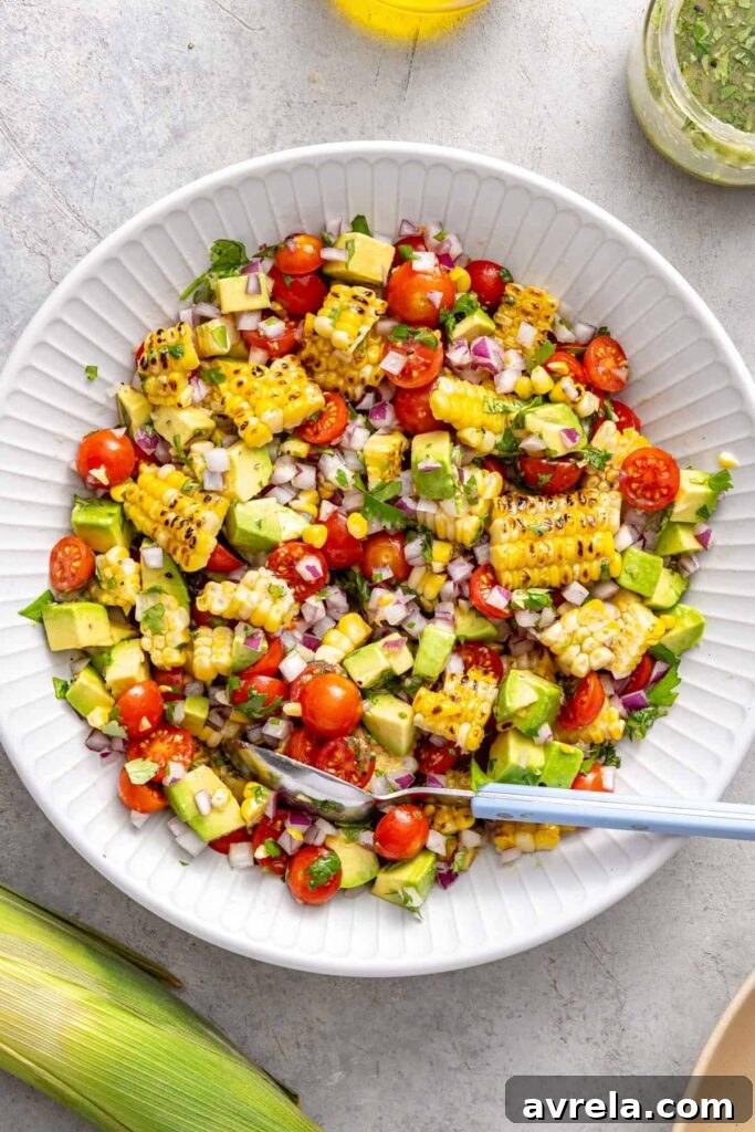 Fresh Corn and Tomato Summer Salad with Basil and Lime 2 Tossing corn and tomato salad with cilantro lime dressing