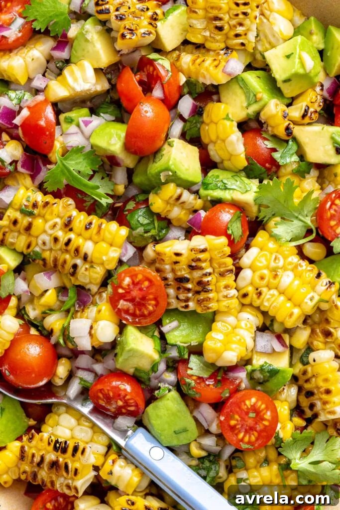 Fresh Corn and Tomato Summer Salad with Basil and Lime 3 Detailed view of charred corn salad tossed in cilantro lime dressing