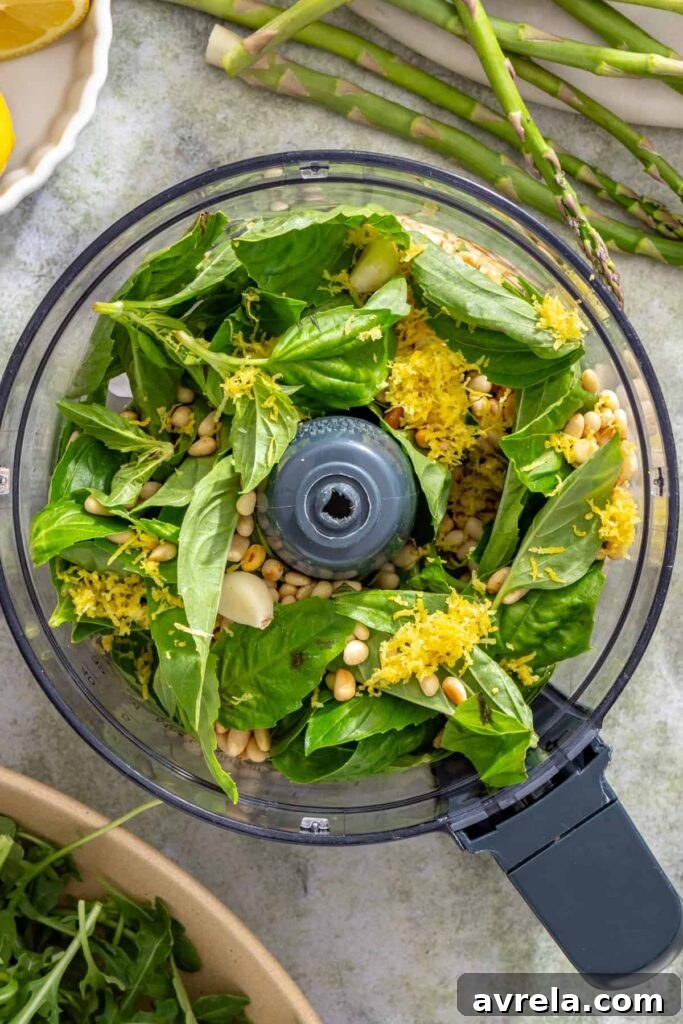 Basil, pine nuts, garlic, and lemon zest in a food processor for homemade lemon pesto