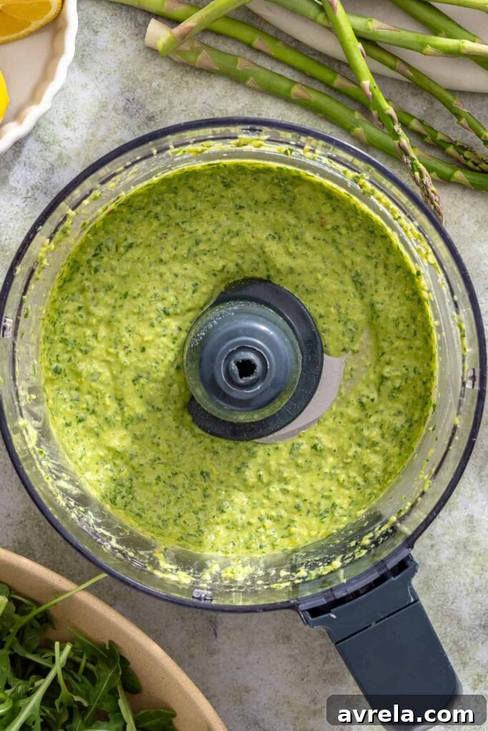 Fresh lemon basil pesto being blended until smooth and textured