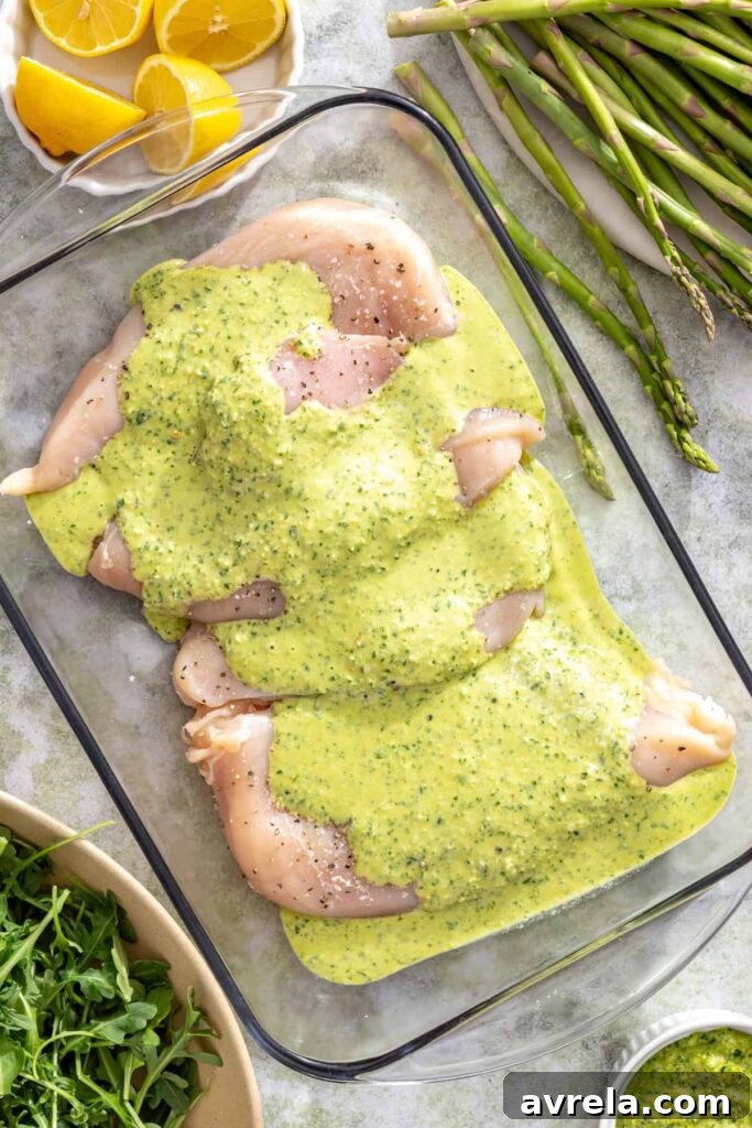 Chicken breasts coated in lemon pesto marinade before grilling
