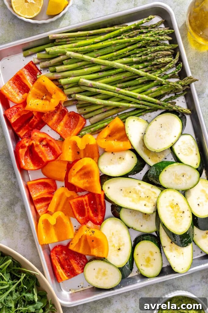 Zucchini, asparagus, and bell peppers tossed with olive oil before grilling