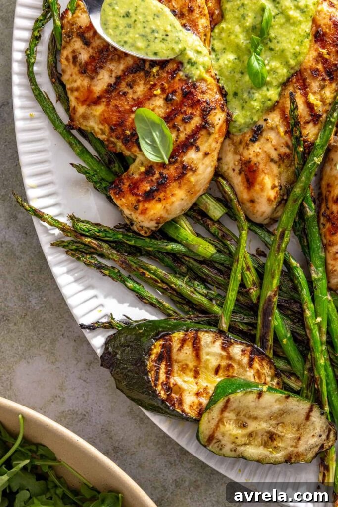Colorful grilled vegetables served alongside lemon pesto chicken
