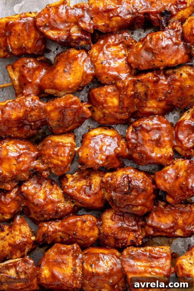 Close-up of juicy grilled BBQ chicken skewers with smoky seasoning