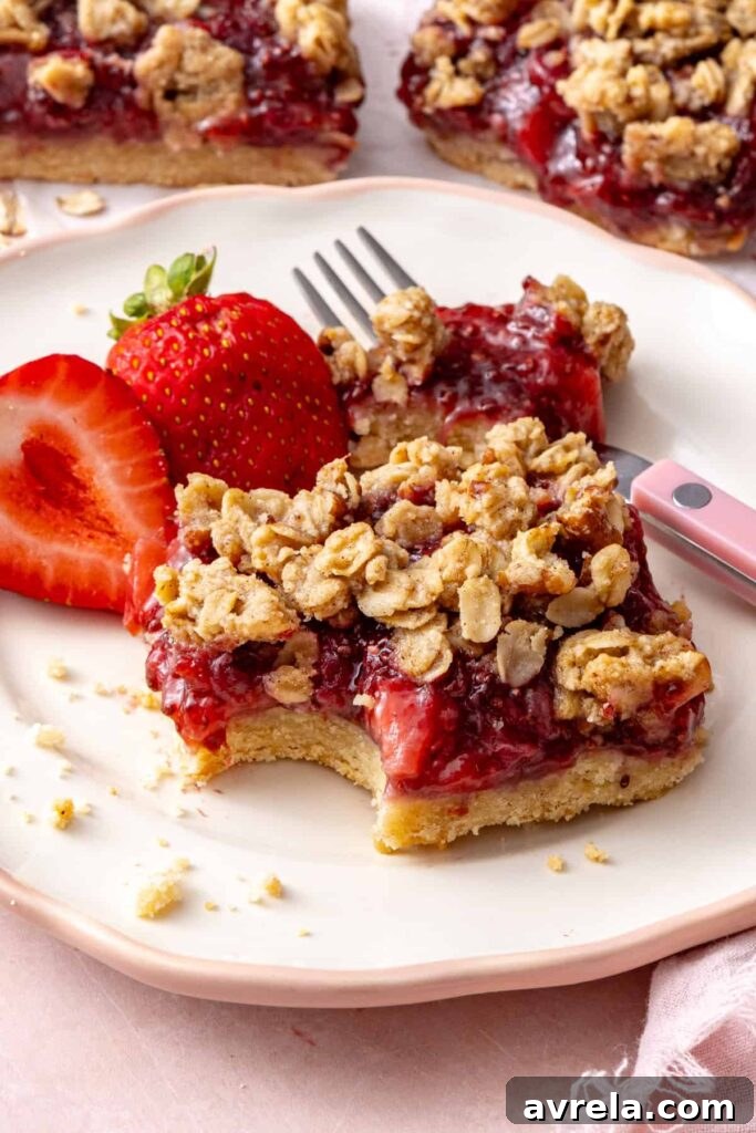 Single strawberry oatmeal bar served on a plate for breakfast or dessert.