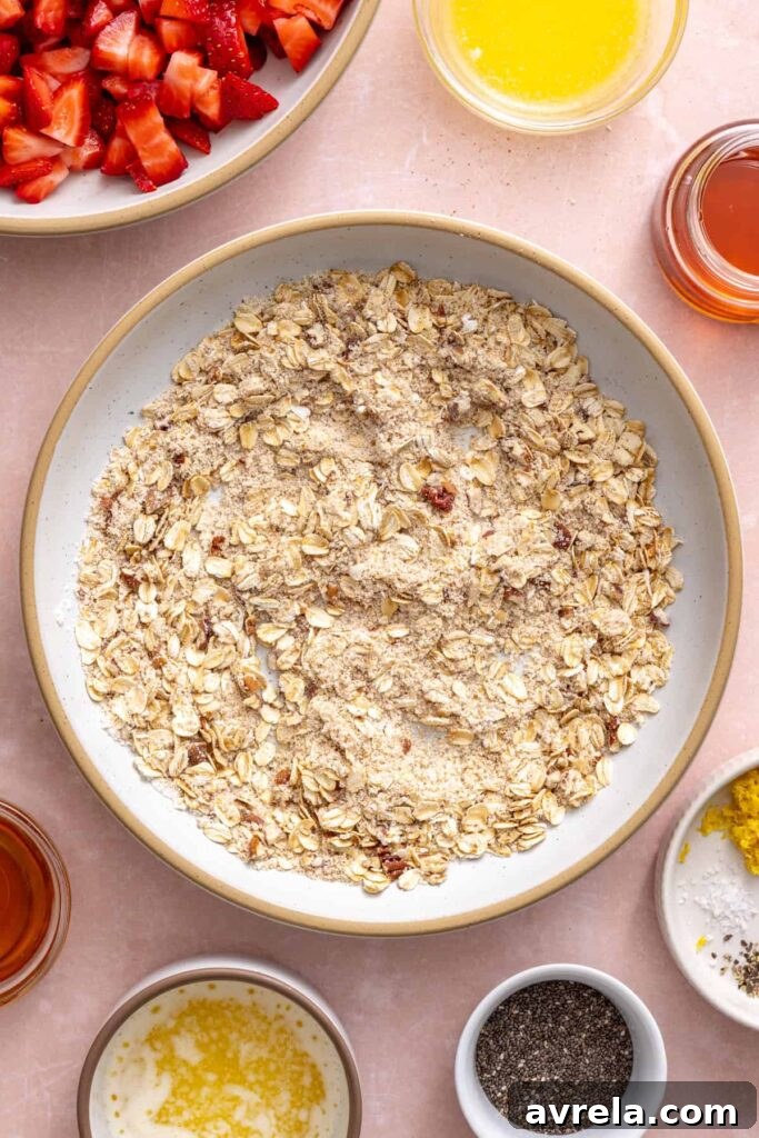 Mixing the oat crumble topping for homemade strawberry oatmeal bars.