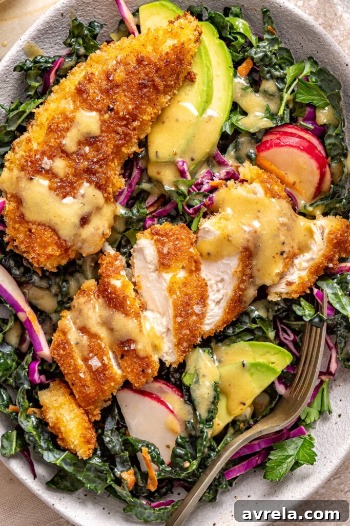High-protein chicken kale salad with crunchy coating and creamy dressing