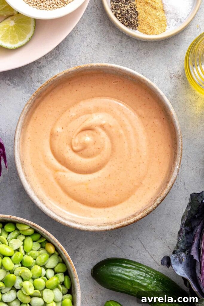 Creamy dairy-free bang bang sauce prepared for drizzling over crispy air fryer bang bang shrimp.