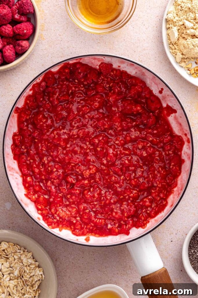 Raspberries simmering to make the jam for peanut butter and jelly overnight oats