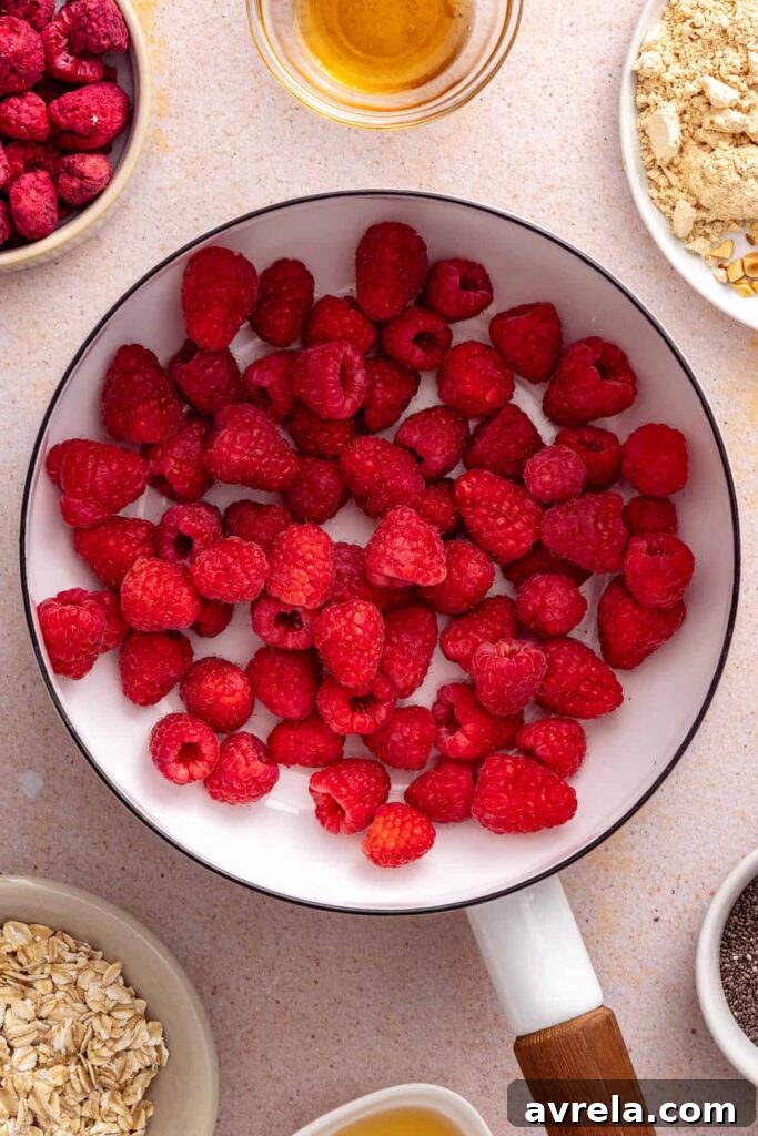 Fresh raspberries cooking in a saucepan for homemade raspberry chia jam