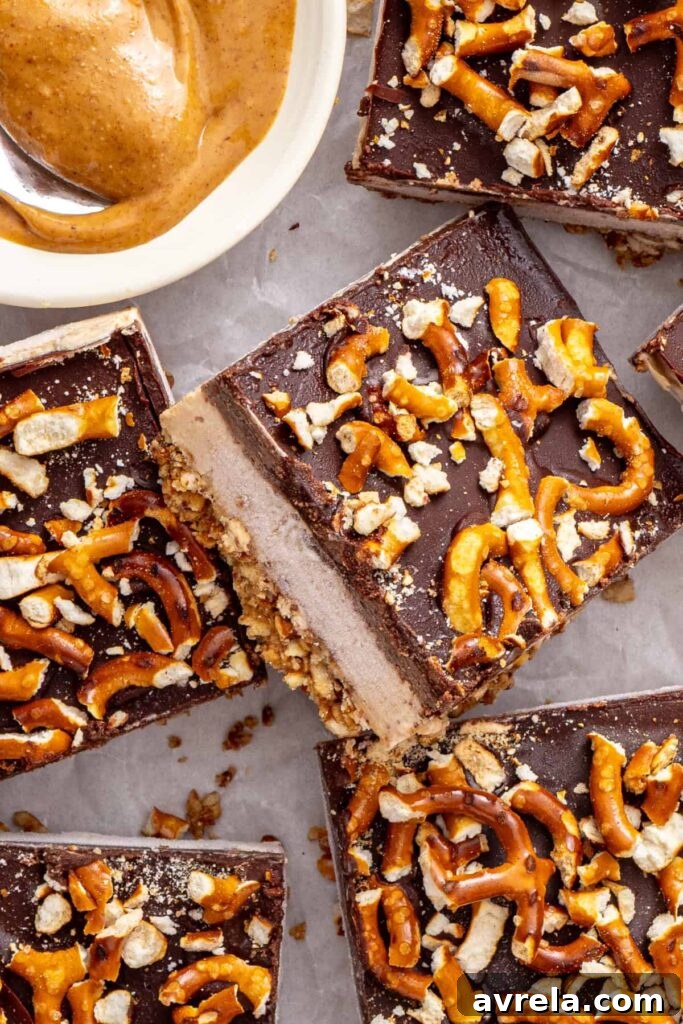 Close-up of frozen peanut butter pretzel bars showing the creamy filling and chocolate topping.