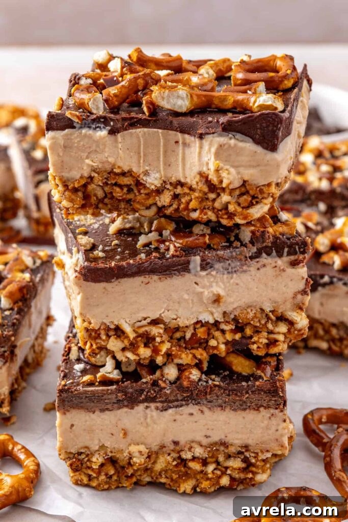 Stacked frozen peanut butter pretzel bars showing the creamy peanut butter filling.