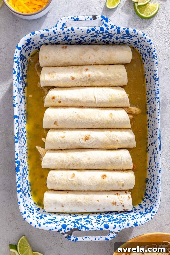 Baked Creamy Chicken Enchiladas with Salsa Verde 5 Rolled chicken enchiladas arranged seam-side down in a baking dish