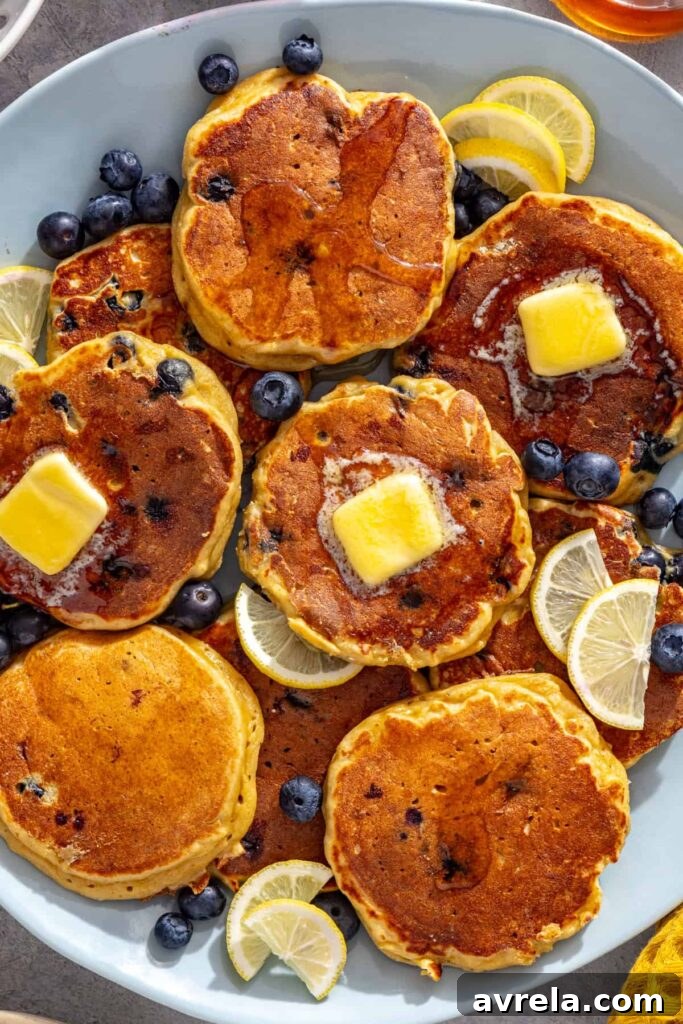 High-protein cottage cheese pancakes topped with melting butter and fresh blueberries