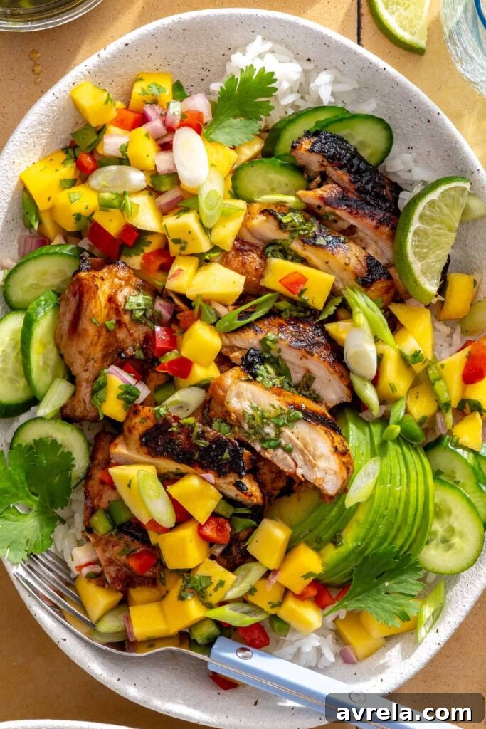 close-up of honey lime grilled chicken with mango salsa and cilantro-lime drizzle