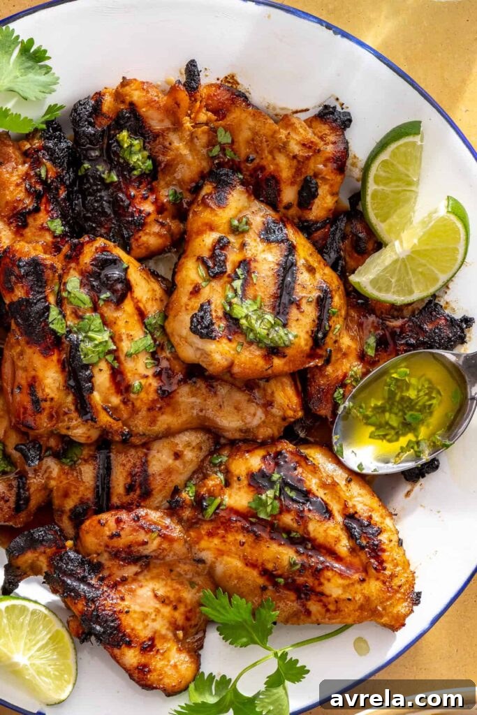 Drizzling cilantro-lime sauce over honey lime grilled chicken