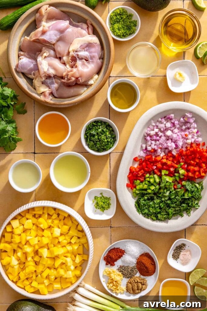 Ingredients for honey lime grilled chicken with mango salsa including chicken thighs, fresh mango, lime, cilantro, garlic, avocado, and spices