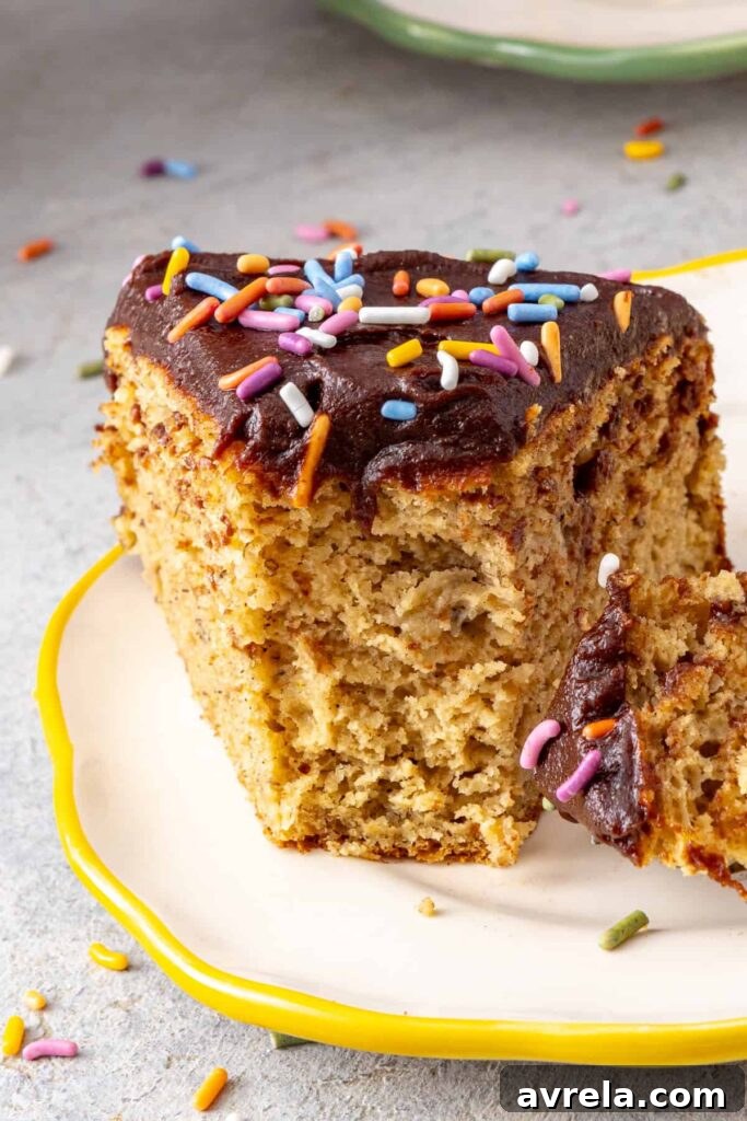 Soft and fluffy healthy banana birthday cake slice with a bite taken out to show texture