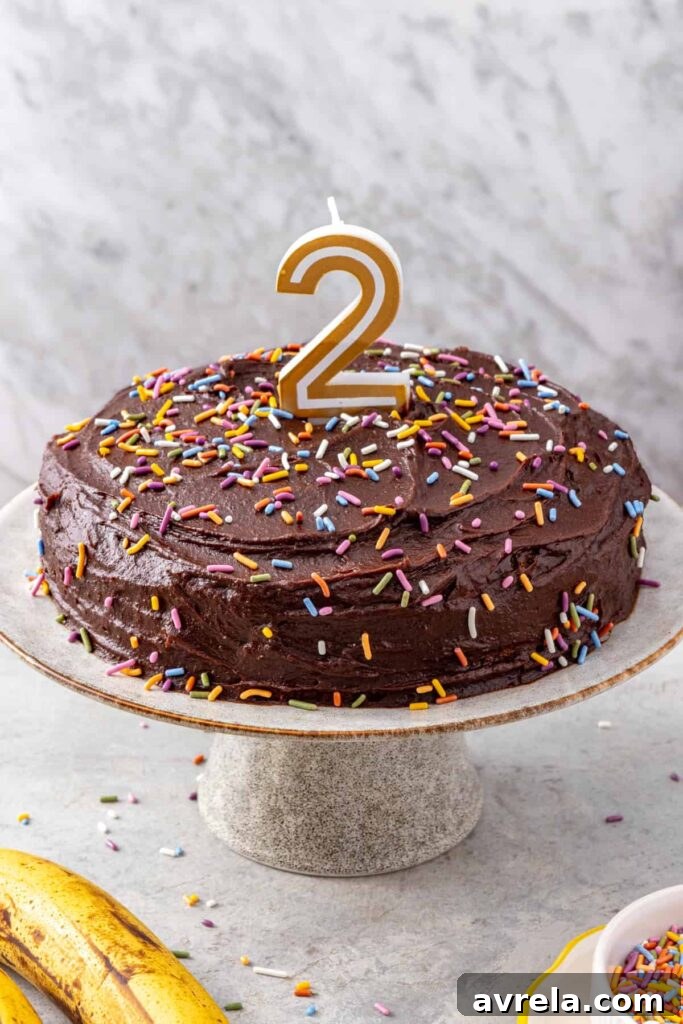 Healthy birthday cake for kids decorated with rainbow sprinkles and a number 2 candle